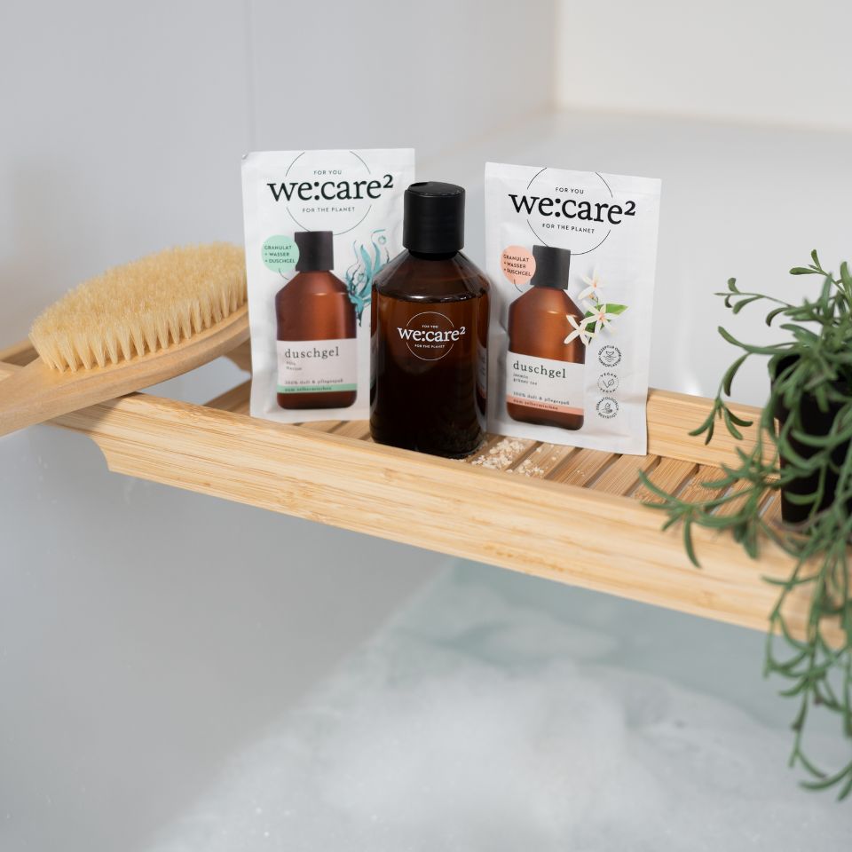 we care Duschgel und Duschgelpulver auf einer Badewanne